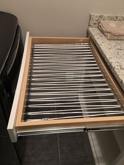 Wanted a way to hang damp clothes for drying without having them out in plain view. Removed the bottom from laundry room drawer. Screwed eyelet screws into drawer frame and "strung" clothesline in a zig-zag pattern and secured with cable clamps.