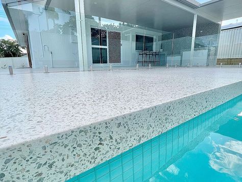 Polished Concrete Around Pool, Concrete Around Pool Ideas Design, Polished Concrete Pool Surround, Tiled Pool Area, Terrazzo Pool Deck, Honed Concrete Pool, Honed Concrete Pool Surround, Santorini Backyard, Kidney Shaped Pool Ideas