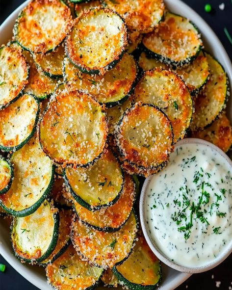 Make crispy baked zucchini chips with a tangy Greek yogurt ranch dip. A healthy, delicious snack perfect for any occasion! Veggie Chips Recipe, Yogurt Ranch Dip, Greek Yogurt Ranch Dip, Baked Zucchini Chips, Yogurt Ranch, Greek Yogurt Ranch, Crispy Zucchini, Zucchini Chips Baked, Baked Zucchini