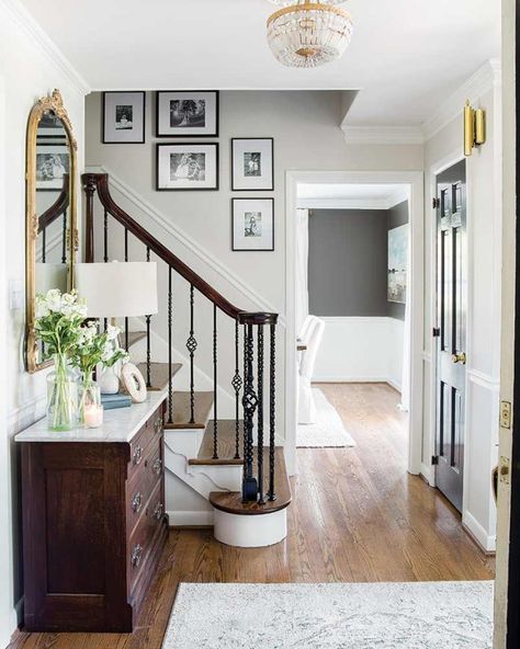 See the Transformation: Brick Colonial Turned Charming Farmhouse - The Cottage Journal Brick Colonial House, Stairway Gallery Wall, Black Stair Railing, Foyer Paint, Colonial House Interior, Ideas Entryway, Black Stairs, Foyer Ideas, Colonial Farmhouse