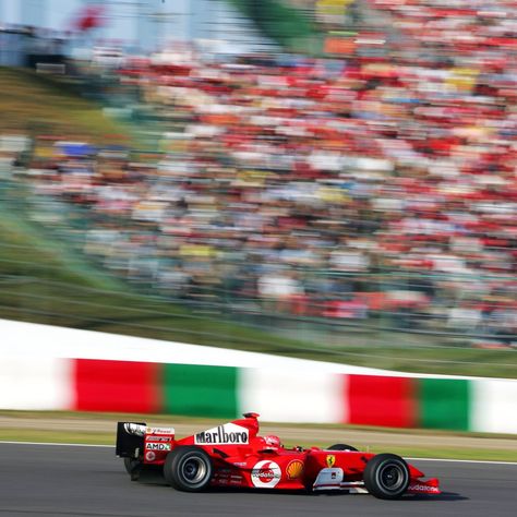 Newly crowned seven time world champion Michael Schumacher in his Marlboro Ferrari F2004 speed past the spectators at the final bend of the Suzuka Circuit during the Japanese Grand Prix, 2004. Ferrari F2004, Suzuka Circuit, Japanese Grand Prix, Michael Schumacher, World Champion, Motor Racing, Car And Driver, Worlds Of Fun, Back In The Day