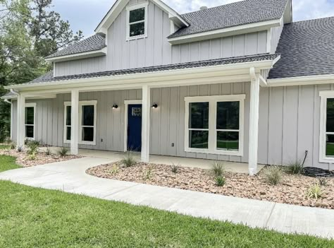 Light Grey Vertical Siding, Light Grey Modern Farmhouse Exterior, Light Grey Siding White Trim, Gray Exterior Farmhouse, Light Gray Ranch House Exterior, Gray Blue Siding House, Light Grey Houses Exterior, Light Grey House Black Roof, Gray Exterior House Colors Ranch Style