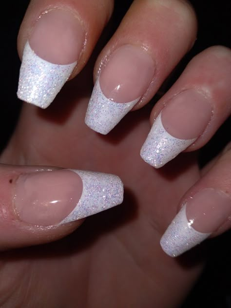 The photo only shows one hand but All 10 of my nails are coffin style. Each have a beautiful, shimmery white French tip topped off with a nice clear glossy top coat. Sparkly French Tips Coffin, Glitter French Tip With Rhinestones, White Nail Silver Tip, Nails For Pageant, White French Glitter Nails, Glitter French Tips Coffin, French Tip Sparkly Nails, Glittery White French Tip Nails, Shimmer French Nails