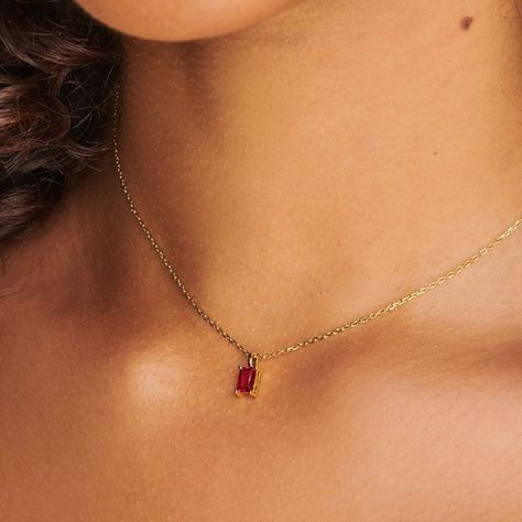 A dainty stone and delicate metallic chain are combined to create this Gold Pendant Necklace in brilliant ruby, your new favorite wear-anywhere accessory.   The birthstone for the month of July is Ruby. This bold, saturated red gemstone helps the wearer overcome challenges and symbolizes courage and passion.  Authentic ruby stone; Made of 14K gold plated sterling silver.   Hypoallergenic, nickel, and lead-free. Tarnish resistant. H2O sensitive. We recommend taking it off during the shower or going to the pool.