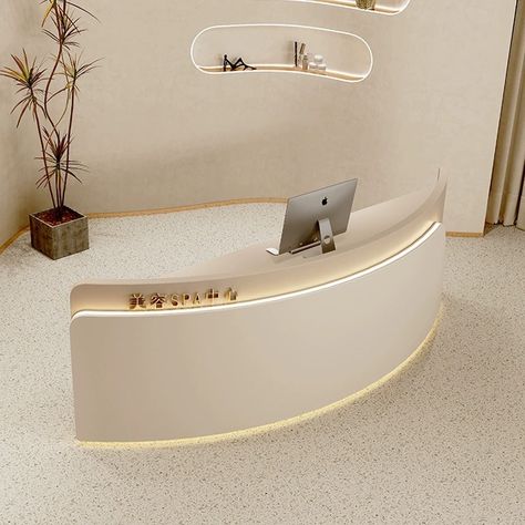 This stylish reception desk combines a minimalist design with a touch of modern elegance, creating a welcoming focal point for your salon space. The semi-circular shape adds a contemporary flair, while the clean lines and subtle curves exude sophistication. Crafted for both functionality and aesthetics, this front desk is ideal for creating a chic and organized reception area that leaves a lasting impression on your clients. Upgrade your salon experience with this versatile and trendy addition. Curved Salon Reception Desk, Curved Desk Design, Minimalist Beauty Room, Beautiful Reception Area, Beauty Salon Interior Design Minimalist, Minimalist Reception Design, Salon Reception Area Design, Spa Reception Area Waiting Rooms, Modern Front Desk Reception Areas