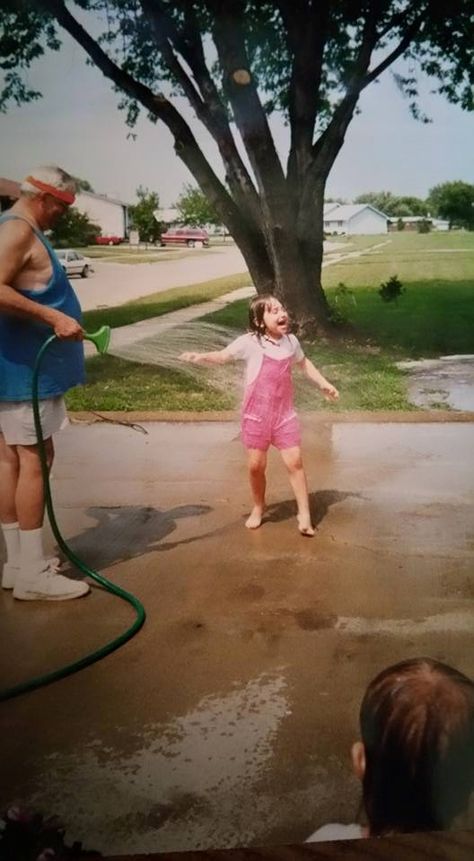 1. This photo, a momento from my childhood, shows me and my grandpa playing with the hose on a hot summer day back in the early 2000s. 2000s Childhood Pictures, Early 2000 Childhood, Early Childhood Aesthetic, 00s Childhood Nostalgia, Hot Summer Day Aesthetic, Early 2000s Summer Nostalgia, Summer Childhood Aesthetic, Childhood Summer Nostalgia, Childhood Memories 2000 Early 2000s