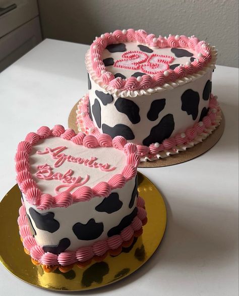 Birthday cake with cow print icing and pink piping with Aquarius Baby and 25 written on it Cow Print Bday Cake, Western Pink Cake, Western 20th Birthday Cake, Cow Print 21st Birthday Cake, Pink Cowgirl Cake Ideas, Cow Heart Cake, Cow Print Heart Cake, Cow Girl Birthday Party Theme Adult, Cow Bday Cake