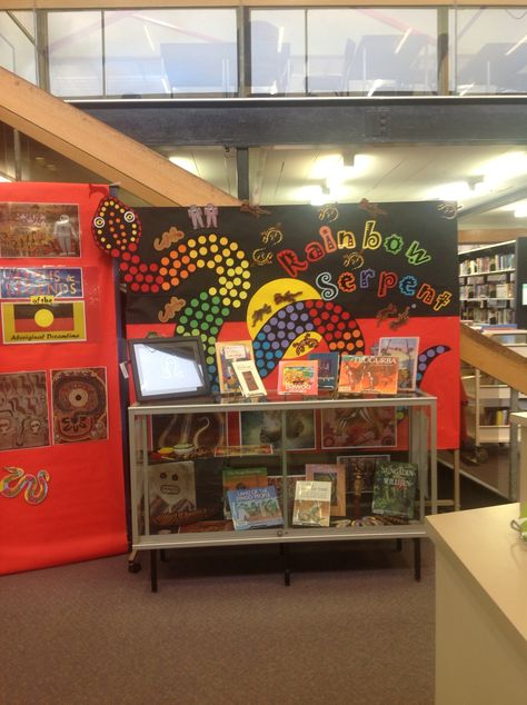 Our gorgeous Rainbow Serpent and Dreamtime display by our wonderful Library Technician Alana! Aboriginal Classroom Display, The Rainbow Serpent Activities, Naidoc Week Display Ideas, Nadoc Craft, Library Technician, Naidoc Week Activities, Reconciliation Week, Rainbow Display, Aboriginal Symbols