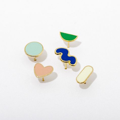 One of everything, please! Mix and match with the Enamel Stud Earring Pack, featuring one each of the Cream Bar, Teal Circle, Green Half Circle, Cobalt Squiggle, and Pink Heart Earrings. Each is approximately 1/2" in size, and features a sweet enamel shape in complementary hues on gold-plated brass posts with matching butterfly post backs. Naturally hypoallergenic and nickel free for sensitive ears, you choose your own adventure! Earring Pack, Giving Keys, Pink Heart Earrings, Enamel Stud Earrings, Branding Inspo, Geometric Studs, Shrink Plastic, Plastic Jewelry, Stud Set