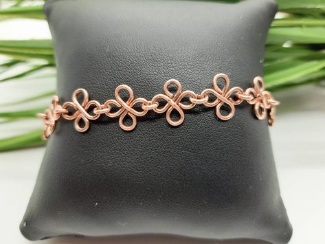 "Unusual pure copper bracelet featuring celtic style links, joined to form a delicate feminine chain, handmade in the UK. This unique dainty bracelet has been made by hand forming copper wire into individual links that almost look like butterflies. The copper is 100% recycled and untreated. The bracelet fastens with a simple hook. The bracelet is lightweight and comfortable to wear, the neutral colour suits all skin tones. I will hand make your bracelet to order, please choose a length approximately 1/2\" - 1\" (1.5 - 2.5cm) greater than your wrist measurement. (I can make this longer or shorter than the listed measurements, please contact me if you require a different length) Copper will naturally tarnish and darken over time giving it a lovely antique look. However, it can easily be clea Wire Chain Links, Copper Chain Bracelet, Handmade Copper Bracelet, Copper Bracelets, Wire Wrap Jewelry Designs, Delicate Feminine, Anniversary Gift For Wife, Wire Jewelry Designs, Celtic Style