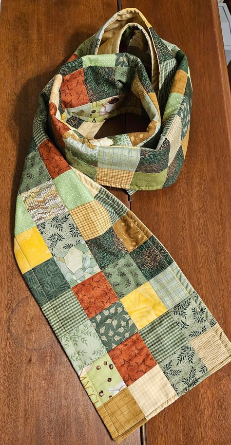 Who says quilts need to stay indoors on a bed?  This winter, cozy up and wear this custom Gold & Green quilted scarf.  Inspired by my mom, Elaine, this scarf reflects her talent for quilting and her eye for superb color combinations.  Elaine's Quilted Scarf is fitting for those chilly winds and snowy nights.  Handmade in our Nashville, TN studio. Materials: 100% Premium Quilting Cotton Fabric 100% Cotton Inner Batting Size: Width: 8 inches Length:  66 inches smoke free studio Quilted Scarf Pattern, Fabric Scarf Pattern, Handmade Scarfs Ideas, Quilted Shawls, Quilt Scarf, Quilted Scarf, Quilted Shawl, Scarf Sewing, Scarf Sewing Pattern