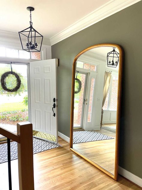 Foyer view with front door open, walls painted Sherwin Willams adaptive shade and floor leaner mirror Sherwin Williams Adaptive Shade, Olive Green Home Decor, Green Home Decor Ideas, Olive Green Rooms, Sherwin Williams Paint Colors Green, Green Interior Paint, Olive Living Rooms, Simple Entryway, Olive Green Bedrooms