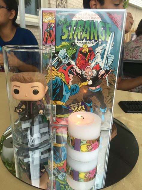 Comic themed centerpiece. 3/4 Anime Centerpiece, Marvel Centerpiece Ideas Wedding, Marvel Centerpiece Ideas, Marvel Wedding Ideas, Funko Pop Wedding Centerpiece, Marvel Wedding Centerpieces, Avengers Centerpieces Ideas, Comic Book Centerpieces, Marvel Wedding Table Decorations