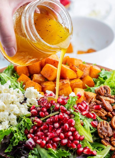 Apple Cider Vinaigrette being poured onto a fall salad with butternut squash. Fall Harvest Roasted Butternut Squash And Pomegranate Salad, Roasted Acorn Squash Salad, Fall Salad With Butternut Squash, Warm Butternut Squash Salad, Butternut Squash Fall Salad, Fall Harvest Salad Butternut Squash, Acorn Squash Salad, Apple Vinaigrette, Salad With Butternut Squash