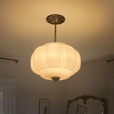 This vintage style recessed shade features a milk glass shade and an oiled brass frame, which creates a cozy atmosphere with the warm glow of soft light emanating through the milk glass shade. The brass frame is oiled to reveal a classic and elegant metal texture that is durable and easy to match with a variety of decor styles. The overall vintage style of the chandelier makes it suitable for use in living rooms, dining rooms, bedrooms and other spaces, adding a unique flavor to your home. Designed to illuminate your bedroom, living room, entryway, dining room, or even a cozy corner in your restaurant or coffee shop, this pendant light is a testament to the art of timeless design. Crafted with a golden metal base that exudes a warm glow, it pairs beautifully with the milk glass pendant lig Milk Glass Pendant, Milk Glass Pendant Light, Glass Hanging Lamp, Retro Pendant Lights, Pendant Lighting Bedroom, White Pendant Light, Metal Texture, Cozy Atmosphere, Glass Pendant Light