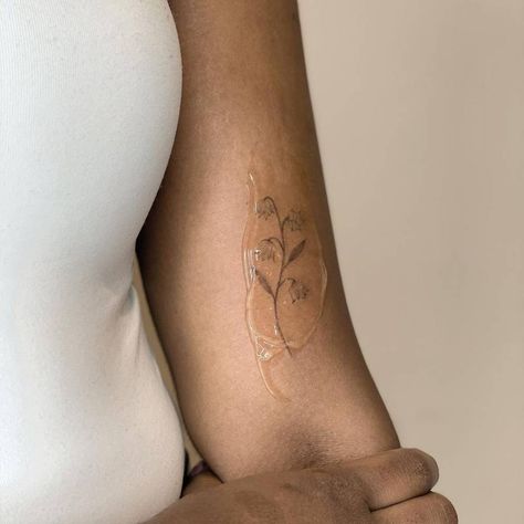 Lily Of The Valley Tattoo Detailed, Cute Tiny Tattoo Placement, Lily Of The Valley Tattoo Side Rib, Tattoo Ideas Lily Of The Valley, May Lily Of The Valley Tattoo, Lily Of The Valley Moon Tattoo, Fine Line Tattoo Dark Skin, Dainty Lily Of The Valley Tattoo, Flower Tattoo On Bicep