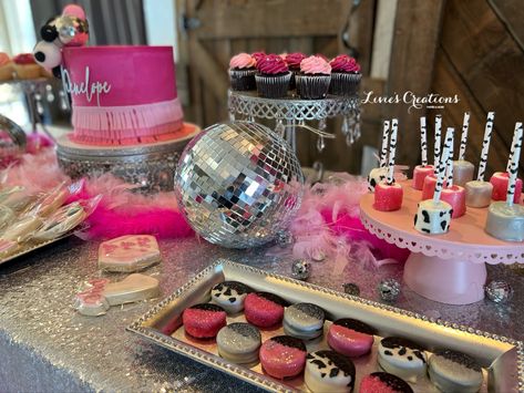 Treat table for a disco cowgirl 1st birthday Western Disco Birthday Cake, Cowgirl Treat Table, Diy Disco Cowgirl Decor, Disco Party Treat Table, Disco Cowgirl Pinata, Rhinestone Cowgirl Birthday Cake, Disco Cowgirl Party Table, Disco Cowgirl Table Decorations, Disco Cowgirl Dessert