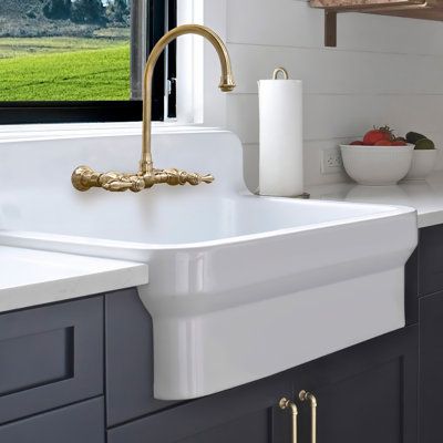 This exceptional sink features a generous size and a high backsplash, offering ample space for all your kitchen needs while adding a touch of sophistication to your kitchen décor. Crafted with precision and durability in mind, this sink is built to withstand the rigours of daily use while maintaining its timeless beauty. Elevate your kitchen with this solid fireclay kitchen sink, and experience the epitome of size, style, and practicality. 30" single bowl fireclay kitchen/utility sink with a hig Apron Front Bathroom Sink, High Back Sink Kitchen, Kitchen Sink With Backsplash, High Back Kitchen Sink, Unique Kitchen Sink Ideas, Florida Mudroom, Cottage Kitchen Sink, High Back Farmhouse Sink, Laundry Sink Ideas