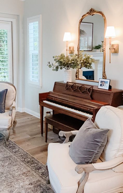 library sconces Piano With Sconces, Mid Century Classic Living Rooms, Cottage Piano Room, How To Style A Piano Decorating Ideas, Round Desk Table, Piano In Sitting Room, 1968 Home Aesthetic, Decor With Piano, Styling Top Of Piano