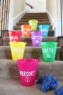 Game: a fun planet toss on the stairs with bean bags and buckets. Planet Party, Rocket Party, Astronaut Party, Space Theme Party, Outer Space Party, Space Camp, Outer Space Theme, Space Activities, Outer Space Birthday