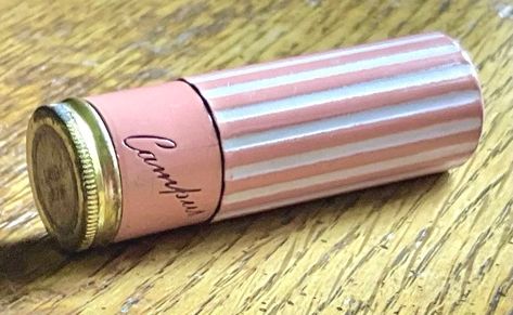 Offered is a rare early lipstick tube signed Campus in script. The tube has lipstick and is unused, but the lipstick would not be safe to use now. The tube has pizzazz. The bottom of the tube is solid pink enamel, the top has pink and white vertical enamel stripes. It is super cute and unusual. Inside the tube is inscribed "distributed by COLONIAL DAMES, HOLLYWOOD U.S.A. , NOT CONNECTED WITH ANY SOCIETY, MADE IN U.S.A.,". I am not sure what that indicates, maybe a sample, or a door prize, but th Antique Makeup, Lipstick Vintage, Infinite Money, Lipstick Container, White Lipstick, Cute Lipstick, Beauty Rules, Lipstick Tube, Vintage Cosmetics