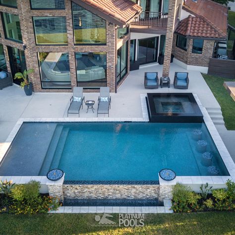 This beautiful pool has a tanning ledge with gushers, an infinity edge, and a reflective spa. Also, the concrete paver decking around the pool provides space for seating and lounging areas. Lastly, an outdoor structure offers a perfect space for an outdoor kitchen and a gathering area. The project is the recipient of the 2019 World Best Pool Award by Pebble-Tec.
Designer - Ian Espada
Builder - Platinum Pools, Houston, TX Swimming Pools Ideas, Kleiner Pool Design, Rectangle Pool, Dream Backyard Pool, Pools Backyard Inground, Swimming Pool Landscaping, Pool Remodel, Pool Landscape Design, Small Pool Design