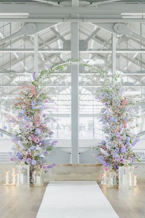 What is lilac and cream and pretty all over? This darling micro wedding in a spacious Vancouver loft. The minimalist wedding venue set the stage for a celebration focused on quality, not quantity, and with that came a gorgeously lush floral backdrop for the ceremony, a velvet lounge overlooking the dinner setup of vintage walnut desks-turned-dining tables and an overhead floral installation bursting with texture and dimensions. Pastel Wedding Ceremony, Lilac Wedding Themes, Lavender Wedding Theme, Lilac Wedding, Cream Wedding, Floral Backdrop, Theme Color, Pastel Wedding, Lavender Wedding