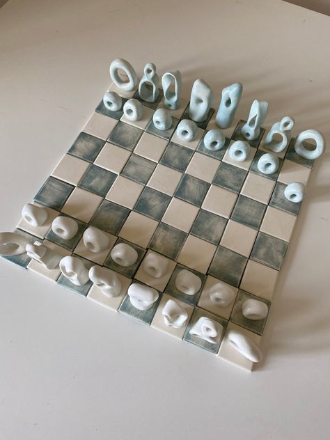 Pre-orders ship 4-7 weeks from date of purchase. A playable showpiece chess set. Hand sculpted in porcelain. Board is made up of individual tiles 1 5/8 x 1 5/8*. Original design. Chess pieces are annotated on the bottom. *measurements are approximate Creative Chess Board, Cute Chess Set, Ceramic Chess Pieces, Chess Pottery, Clay Chess Board, Unique Chess Sets, Chess Ceramic, Clay Chess Set, Chess Pieces Design