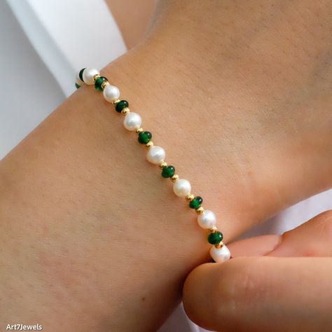 Delight her with our Dainty Emerald & Pearl Beaded Bracelet, featuring vibrant green emeralds, lustrous freshwater pearls, and delicate gold beads. This sophisticated bracelet complements any outfit, making it perfect for any occasion from birthdays to special celebrations. Its adjustable design ensures a comfortable fit for any wrist size. Packaged in an elegant gift box, it's ready to be gifted and cherished, embodying elegance and grace. DETAILED DESCRIPTION// Material:  925 sterling silver Emerald And Pearl Bracelet, Green And Gold Beaded Bracelets, Green Pearl Bracelet, Emerald Green Bracelet, Fancy Beaded Bracelets, Elegant Beaded Bracelets, Seed Bead Patterns Bracelet, Dainty Beaded Bracelets, Green Bracelet Beads