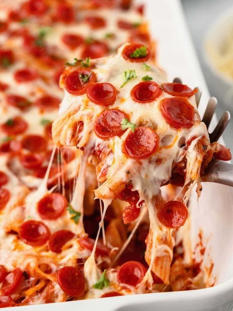 This Pepperoni Pizza Casserole recipe is a family favorite that's loaded with marinara sauce, mini pepperoni slices and two types of cheese! It's the perfect pizza bake for busy weeknights, and easy to personalize with your favorite pizza toppings. Pizza Caserole, Pepperoni Pizza Cake, Pepperoni Pizza Casserole Recipe, Pepperoni Pizza Casserole, Pizza Casserole Recipe, Pepperoni Pasta, Pizza Pasta Bake, Lasagna Casserole, Pizza Casserole