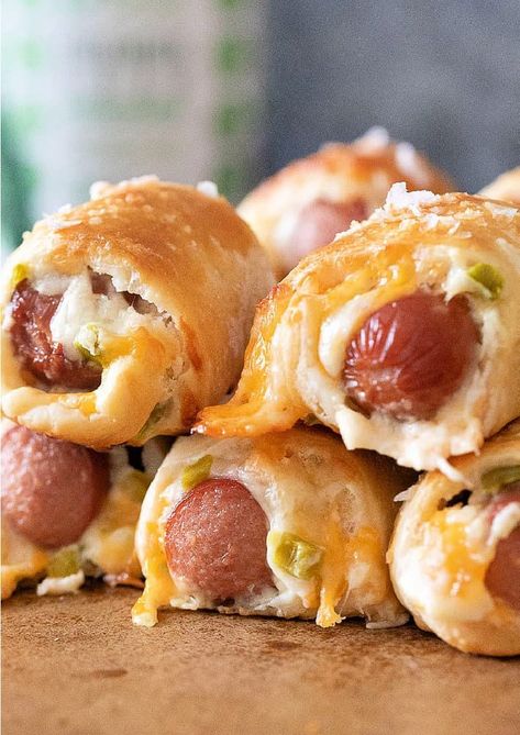 Pigs In a Blanket are classic party fare and a favorite appetizer for all occasions. This "Popper" take on the classic is sure to put Jalapeno Popper Pigs In a Blanket at the top of your recipe list for quick and delicious finger food. #recipes #appetizers #partyfood #hotdogs Hot Dog Wraps Crescent Rolls, Pimento Cheese Pigs In A Blanket, Jalapeño Popper Pigs In The Blanket, Jalepeno Popper Pigs In The Blanket, Cornbread Pigs In A Blanket, Pig Roast Appetizers, Fancy Pigs In A Blanket Recipe, Elevated Pigs In A Blanket, Stuffed Pigs In A Blanket