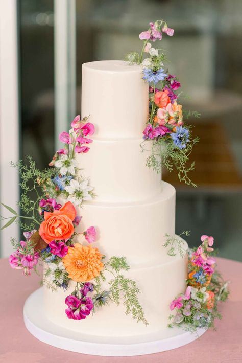 The tiered wedding cake with flowers in bright blue, coral, pink and orange with delicate greenery. May Wedding Food Ideas, Ethereal Spring Wedding, Italian Vineyard Wedding Aesthetic, 3 Tier Wedding Cake With Flowers, Tiered Wedding Cake With Flowers, Summer Wedding Cake Ideas, Spring Wedding Cakes, Wedding Cake With Flowers, Pastel Wedding Theme