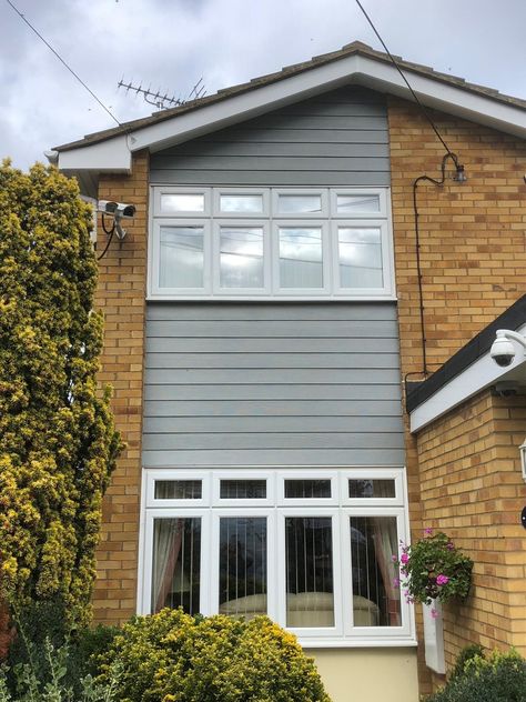 HardiePlank wall cladding. Slate Grey. Canvey Island Essex Front Of House Cladding Ideas, Grey House Facade, Upvc Cladding Exterior, Render And Cladding House Exteriors, Grey Cladding Exterior, House Cladding Exterior, Brick Bungalow Exterior, 1970s House Exterior, Cladding House Exterior