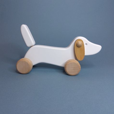 This wooden Dachshund dog will soon become your childs best friend. This Dachshund has a fixed tail and flapping ears that move as he is rolled along. The toy will inspire imagative play. Recommended from age 18 months. This toy measures 18cm x 7cm x 11cm. Toy Dachshund, Wooden Baby Walker, Pottery Inspo, Kids Graphics, Baby Whale, Traditional Toys, Wooden Dog, Easter Birthday, Toy Ideas