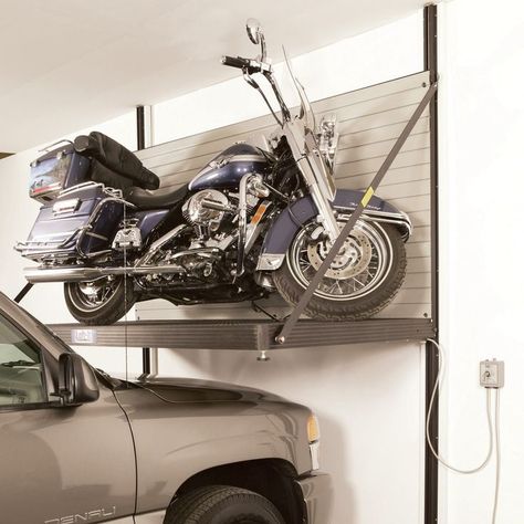 One of the major reasons buyers back away from a motorcycle purchase is that they’d have to park one of their cars outside to leave space for the bike. Hd Fatboy, Bike Lift, Motorcycle Storage, Garage Lift, Garage Workshop Organization, Garage Tool Organization, Garage Storage Solutions, Garage Organize, Garage Remodel