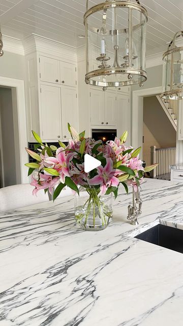 B&C on Instagram: "The Right Vase for the Right Flower 🌸!! A graceful arrangement incorporates balance, proportion, and scale. Save these tips for your tall arrangement: • Tall arrangement requires flowers with thick stems, like Lilies and Hydrangeas; • The rule of thumb is that the flowers you put in a vase should be 2.5 times the height of the vase. The vase on the video is 10 inches tall, so your flowers should stand 25 inches tall. But being off by an inch or two for long-stem flowers won’t make much of a visible difference. • Cut the first stem, and once you are happy with the length, cut all the stems at the same height. • Letting leaves rot in water is one of the best ways to bring your flowers down. Get rid of foliage below the water line, and snip off any leaves that are broken o Lilies Arrangement, Stem Flowers, Large Glass Vase, Long Stem Flowers, Rule Of Thumb, Bring Them Home, Pro Tip, The Flowers, Place Settings