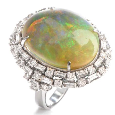 For Sale on 1stdibs - This eye catching cocktail ring boasts of color with a large oval shaped fiery Opal offering bursts of red, green and blue. With the Opal measuring appx. Luxury Cabochon Opal Ring For Engagement, Luxury Multi-stone Dome Ring For Engagement, Sapphire Cocktail Ring, Lab Report, 14k Gold Engagement Ring, Opal Band, Yellow Gold Wedding Band, Jewelry Appraisal, Double Halo