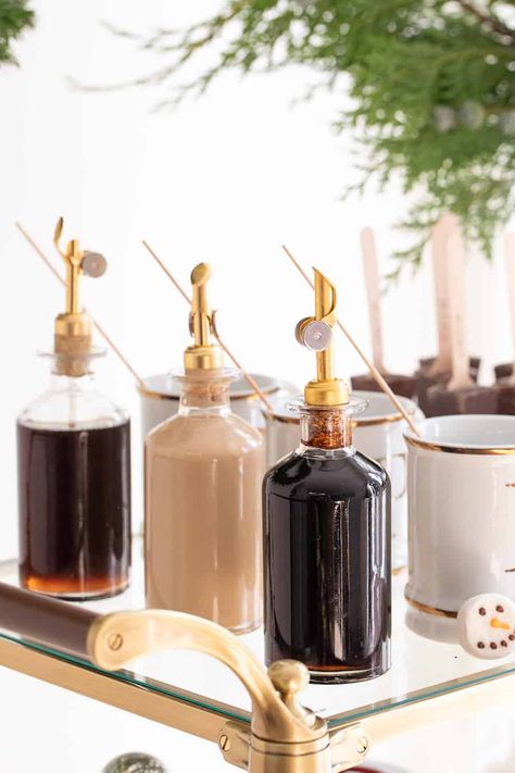 Syrups in glass jars with gold spout Holiday Whobilation, Wedding Hot Chocolate Bar, Vanilla Hot Chocolate, Hot Beverage Bar, Hot Chocolate Bar Party, Holiday Hot Chocolate, Coin Café, Coffee Bar Station, Fun Dessert