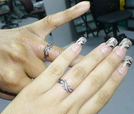 9 Wedding Ring Tattoos Ideas And Designs For Male And Female Marriage Ring Tattoos, Infinity Ring Tattoo, Wedding Ring Finger Tattoos, Tato 3d, Marriage Tattoos, Finger Tattoos For Couples, Ring Tattoo Designs, Wedding Band Tattoo, Tato Dengan Makna