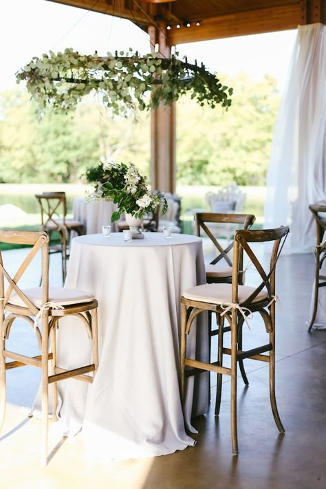 Crossback bar stools, white linens, and greenery for a beautiful cocktail hour. Rentals by Southern Events Party Rental Company | Franklin, Nashville, Middle Tennessee Event Lounge Furniture, Reception Seating Layout, Wedding Cocktail Table, Wedding Cocktail Tables, Seating Layout, Cocktail Table Decor, Cocktail Wedding Reception, Table Decoration Ideas, Wedding Reception Seating