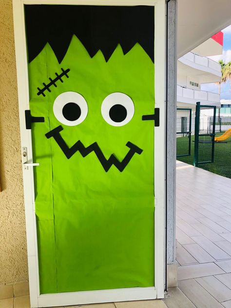 Haloween Door Frankenstein Frankenstein Window Art, Frankenstein Diy Decor, Frankenstein Door Decorations For School, Frankenstein Classroom Door, Halloween Classroom Door Decorations Ideas, Halloween Office Door Ideas, Frankenstein Bulletin Board, Easy Halloween Door Ideas, Halloween Door Decorations Classroom High School