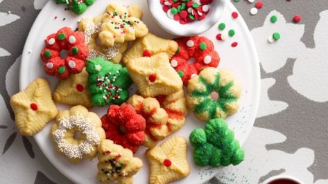 Spritz cookies are famous Christmas cookies from Germany that can be enjoyed year round. They make a great treat for any special occasion. Christmas Spritz, Christmas Spritz Cookies, Cookies With Sprinkles, Drop Sugar Cookies, Spritz Cookie Recipe, Fruit Cake Cookies, Buttery Shortbread Cookies, Rolled Sugar Cookies, Spritz Cookies