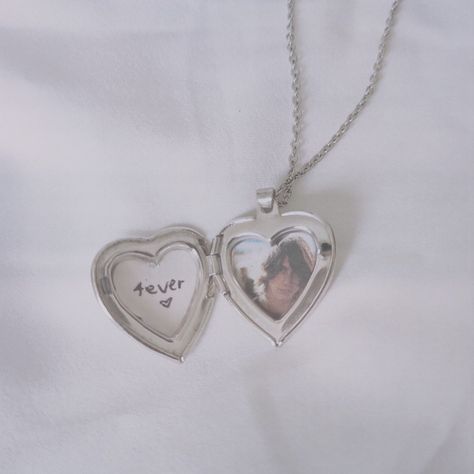 A heart locket necklace with Alex Turner's picture. Heart Locket With Picture, Heart Locket Picture, Silver Heart Locket Aesthetic, Heart Locket Necklace Picture, Picture Locket Necklace, Silver Locket Necklace Aesthetic, Silver Locket Aesthetic, Heart Locket Necklace Aesthetic, Heart Locket Aesthetic