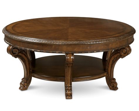 The generous 44" round top of the Old World Round Cocktail Table showcases the beautiful sunburst of book matched cherry cathedral veneers bordered with herringbone inlay and avodire cross banding. Six legs placed around the perimeter give the large top stability and visual balance. A shelf underneath is tucked away from foot traffic and provides strength for the table as well as additional storage/display space. The finish is a rich and warm pomegranate shade that has both depth and clarity, Wood Cocktail Table, Concrete Coffee Table, Living Room Table Sets, Round Cocktail Tables, Hickory Furniture, Occasional Tables, Contemporary Coffee Table, Liberty Furniture, Coffee And Cocktail Tables