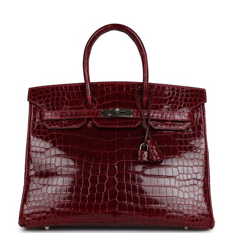 This Birkin 35 is in Rouge H Shiny Porosus crocodile leather with Palladium hardware, tonal stitching, a front flap with two straps, front toggle closure, clochette with lock and two keys, and double rolled handles.The interior is lined in Rouge H chevre leather and has one zip pocket with an Hermes engraved zipper pull and an open pocket on the opposite side.Collection: I squareOrigin: FranceCondition: Pre-owned -Excellent; This bag retains it shape. No plastic on hardware. Moderate scratching Red Birkin Bag, Red Birkin, Hermes Crocodile Bag, Vintage Hermes Bag, Hermes Crocodile, Hermes Birkin Bag, Birkin Bags, Hermes Birkin Handbags, Crocodile Handbags