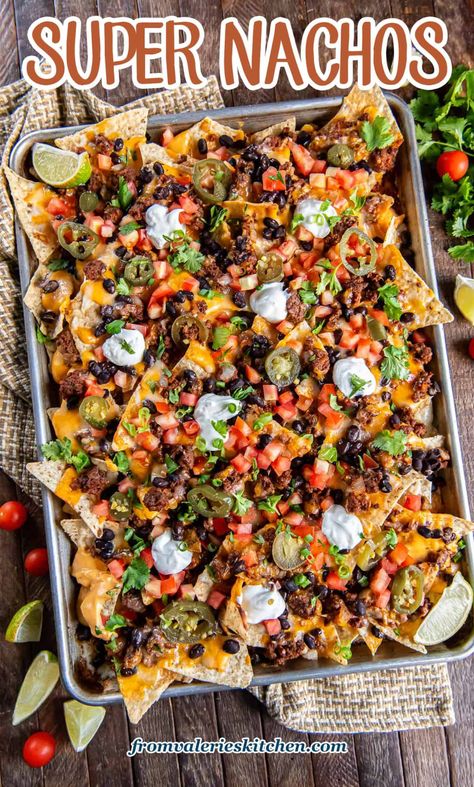 These sheet pan Super Nachos are loaded with ground beef, black beans, homemade nacho cheese sauce, and plenty of freshly shreddded cheese. Just pile on your favorite toppings and dig in! Authentic Mexican Nachos Recipe, Diy Nachos Ground Beef, Black Beans For Nachos, Fully Loaded Nachos, Blackstone Nachos Supreme, Best Homemade Nachos, Black Stone Nachos Recipes, Halloween Nachos Ideas, Hamburger Nachos Recipe Beef