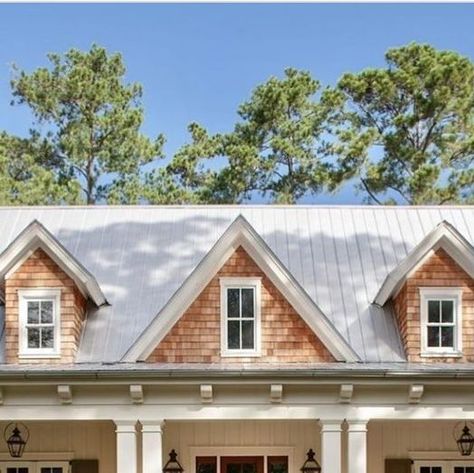 Tamra Lea #Itsahouselovestory on Instagram: "A large and inviting front porch, metal roof, white board and batten siding and contrasting natural cedar shingles on the dormers make for attractive curb appeal. 

Photo: John McManus Fine Art

Original Design by : @courtatkinsgroup

#itsahouselovestory #homedesign #exterior #exteriordesign #archidesign #home #houseandhome #curbappeal #residentialdedign #housedesign" Gables On House Exterior, Cedar House Siding, Porch Metal Roof, White Board And Batten Siding, White Board And Batten, Coastal Home Exterior, Cedar Shingle Siding, Metal Roof Houses, Board And Batten Exterior