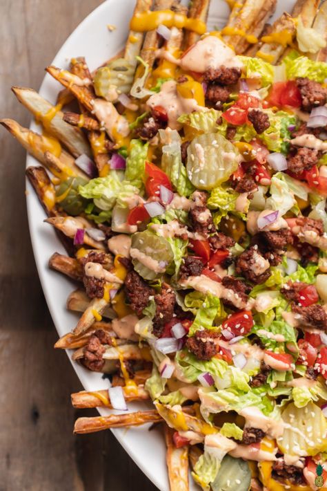 Animal style fries are taken to a whole new level with this McDonald's inspired Big Mac version! They are loaded with everything in the infamous dish-- crumbled vegan burgers, lettuce, tomatoes, pickles, onions, a melty cheese sauce, sesame seeds, and of course, a homemade Big Mac Sauce. #veganized #homemade #animalstylefries #bigmac #bigmacsauce #veganmcdonalds #vegansuperbowl #appetizer #kidfriendly #superbowlsnack #loadedfries #bigmacfries #sweetsimplevegan #consciouschris #vegan Big Mac Fries, Vegan Big Mac, Vegan Burger Patties, Pickles Onions, Homemade Big Mac Sauce, Vegan Super Bowl, Animal Style Fries, Vegan Mcdonalds, Homemade Big Mac