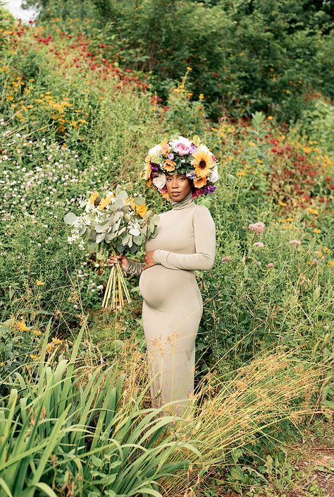 This is a maternity photo of a Black woman with a flower headpiece in the middle of a wildflower field. Unique Maternity Shoot Ideas Fun, Earthy Maternity Shoot, Mother Nature Maternity Shoot, Pregnancy Photoshoot Black Women, Baby Shower Black Women, Earthy Maternity Photos, Mother Nature Photoshoot, Nature Maternity Shoot, Creative Maternity Shoot Ideas