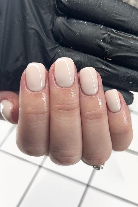 These beautifully manicured short oval nails feature a clean and elegant nude base with a subtle touch of class in the slender white line tracing the curve of each tip. The minimalist design exudes sophistication and makes for a versatile look that's perfect for any occasion.  // Photo Credit: Instagram @gelberry_ Sqovalnails Short, Very Short Oval Nails, Short Round Nails Ideas, Square Oval Nails Short, Short Squoval Nails, Natural French Manicure, Pink Oval Nails, Square Oval Nails, Short Oval Nails